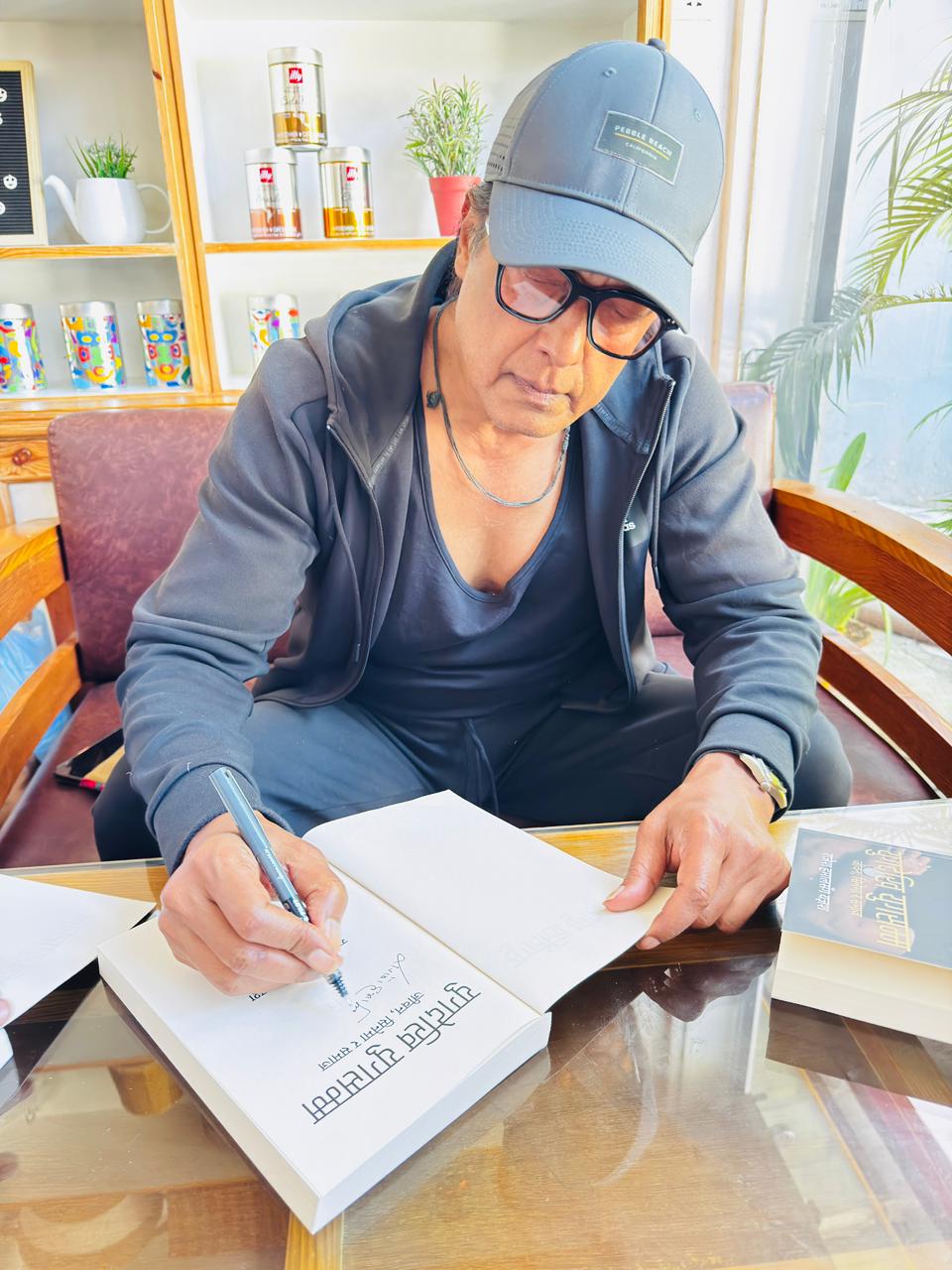 Rajesh Hamal Signing the Book Yug Dekhi Yug Samma for his readers in USA