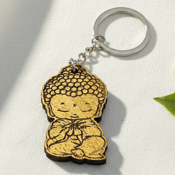 Baby Buddha wooden keychain with engraved meditation design and metal keyring