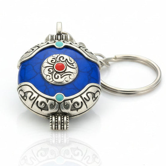 Blue Tibetan Style Round Pendant Keychain with Silver-Tone Detailing and Red Center Stone