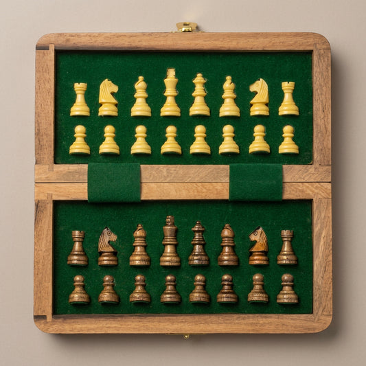 Wooden chess set with connected chessboard and green fabric-lined storage compartment holding 32 chess pieces.