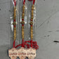 Elegant gold beaded rakhi set with red thread and ornamental design