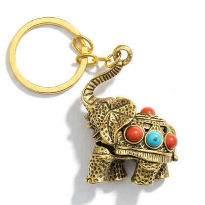 Gold-tone decorative elephant keychain with colorful stone-style accents