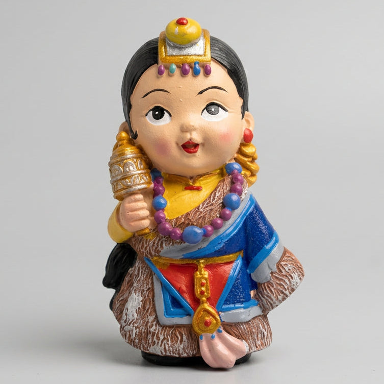 Colorful Himalayan traditional dress girl ceramic fridge magnet featuring decorative jewelry, blue clothing, and a traditional-style head ornament