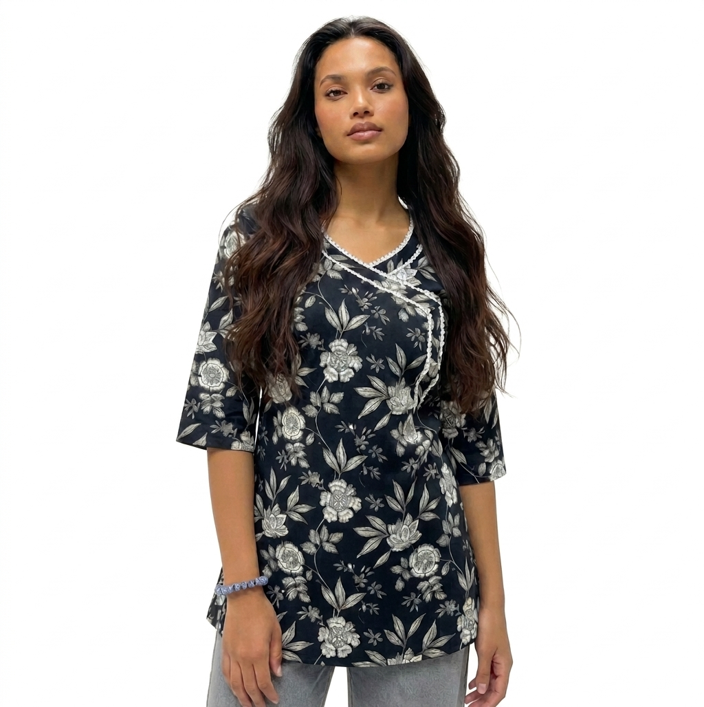 Front view of a woman wearing a black short kurti with an off-white floral botanical print and an Angrakha wrap neckline with white lace details.