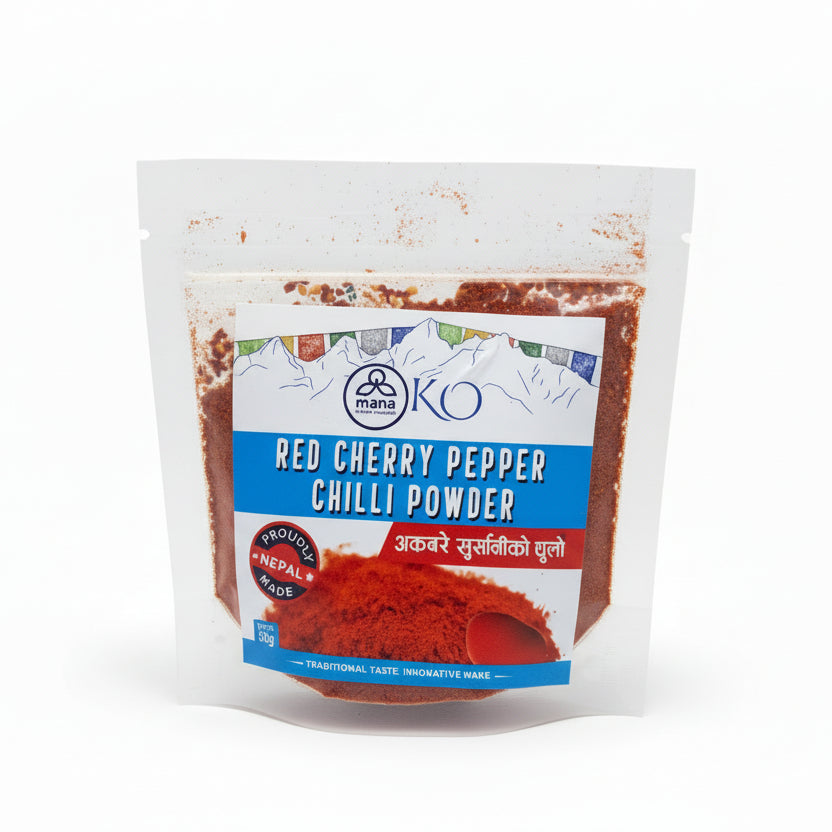 Front packaging of Mana KO Red Cherry Pepper Chilli Powder 50g showing a vibrant pile of ground red chilies and Himalayan prayer flags.