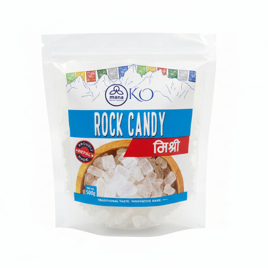 Front packaging of Mana KO Rock Candy (Mishri) 500g showing clear sugar crystals in a wooden bowl with Himalayan mountain sketches.