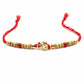 Traditional red and gold beaded rakhi with ornate centerpiece