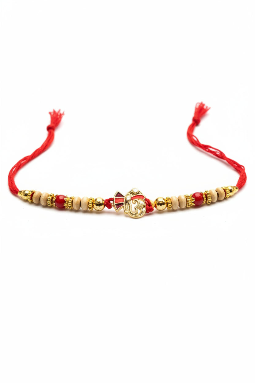 Traditional red and gold beaded rakhi with ornate centerpiece