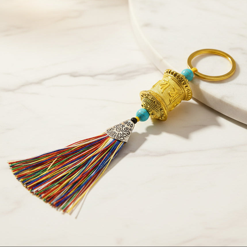 Gold Tibetan prayer wheel keychain with multicolor tassel