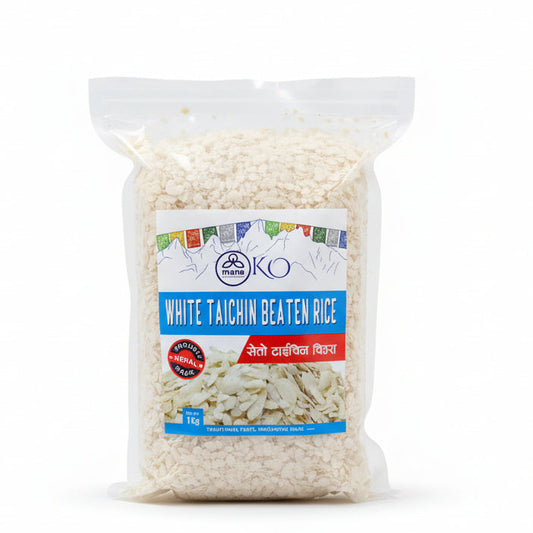 Front packaging of Mana KO White Taichin Beaten Rice (1kg) showing light, flattened rice flakes and Himalayan mountain sketches.