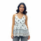 Woman wearing a white halter neck short kurti with geometric ethnic prints